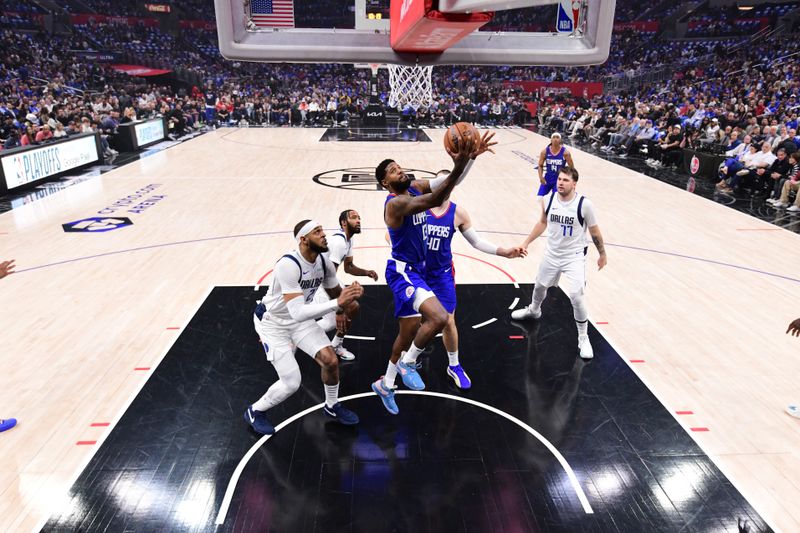 LOS ANGELES, CA - APRIL 21:  Paul George #13 of the LA Clippers drives to the basket during the game against the Dallas Mavericks during Round 1 Game 1 of the 2024 NBA Playoffs on April 21, 2024 at Crypto.Com Arena in Los Angeles, California. NOTE TO USER: User expressly acknowledges and agrees that, by downloading and/or using this Photograph, user is consenting to the terms and conditions of the Getty Images License Agreement. Mandatory Copyright Notice: Copyright 2024 NBAE (Photo by Adam Pantozzi/NBAE via Getty Images)