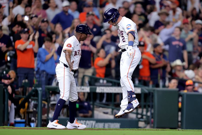 Apr 30, 2024; Houston, Texas, USA; Houston Astros third baseman Alex Bregman (2) celebrates with third base coach Gary Pettis (8, left) after hitting a three-run home run to left field against the Cleveland Guardians during the third inning at Minute Maid Park. Mandatory Credit: Erik Williams-USA TODAY Sports