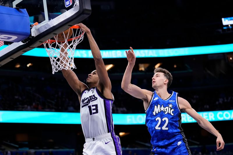 ORLANDO, FLORIDA - MARCH 23: Keegan Murray #13 of the Sacramento Kings dunks the ball against Franz Wagner #22 of the Orlando Magic during the second quarter at Kia Center on March 23, 2024 in Orlando, Florida. NOTE TO USER: User expressly acknowledges and agrees that, by downloading and or using this photograph, User is consenting to the terms and conditions of the Getty Images License Agreement. (Photo by Rich Storry/Getty Images)