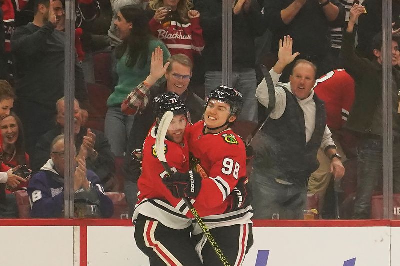 Nov 27, 2024; Chicago, Illinois, USA; Chicago Blackhawks left wing Taylor Hall (71) celebrates his goal against the Dallas Stars with Chicago Blackhawks center Connor Bedard (98) during the first period at United Center. Mandatory Credit: David Banks-Imagn Images