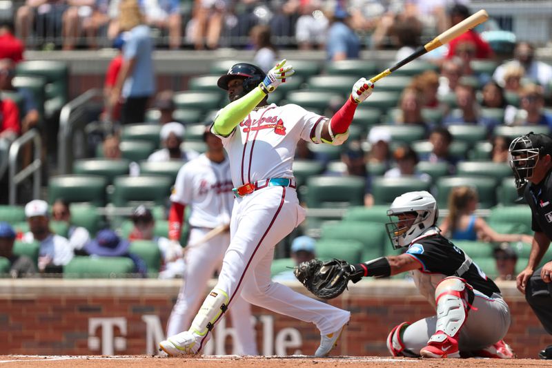 Aug 4, 2024; Cumberland, Georgia, USA; Atlanta Braves designated hitter Marcell Ozuna (20) hits a single in a game against the Miami Marlins in the first inning at Truist Park. Mandatory Credit: Mady Mertens-USA TODAY Sports