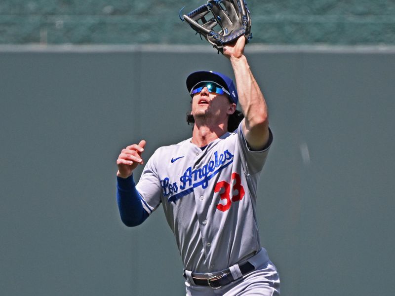 Jul 2, 2023; Kansas City, Missouri, USA;  Los Angeles Dodgers center fielder James Outman (33) catches a fly ball in the sixth inning against the Kansas City Royals at Kauffman Stadium. Mandatory Credit: Peter Aiken-USA TODAY Sports