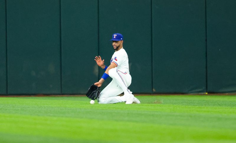 Aug 20, 2024; Arlington, Texas, USA; Texas Rangers center fielder Leody Taveras (3) cannot make a catch during the fourth inning against the Pittsburgh Pirates  at Globe Life Field. Mandatory Credit: Kevin Jairaj-USA TODAY Sports