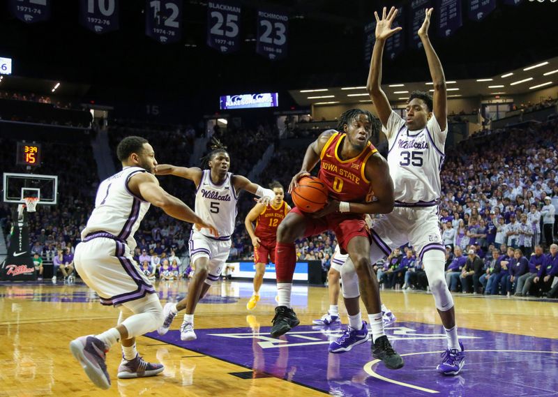 Feb 18, 2023; Manhattan, Kansas, USA; Iowa State Cyclones forward Tre King (0) goes to the basket against Kansas State Wildcats forward Nae'Qwan Tomlin (35) and guards Markquis Nowell (1) and Cam Carter (5) during the second half at Bramlage Coliseum. Mandatory Credit: Scott Sewell-USA TODAY Sports