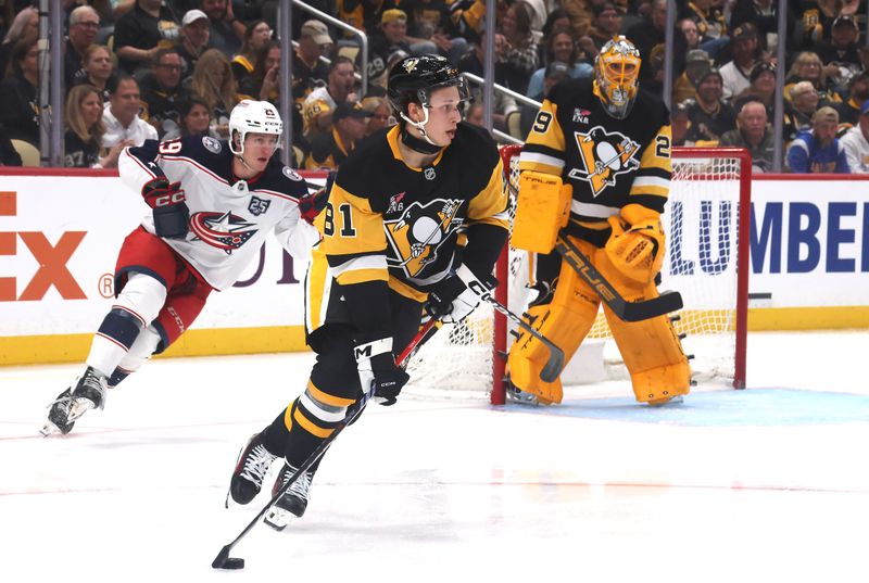 Sep 27, 2025; Pittsburgh, Pennsylvania, USA;  Pittsburgh Penguins center Ben Kindel (81) moves the puck against the Columbus Blue Jackets during the third period at PPG Paints Arena. Mandatory Credit: Charles LeClaire-Imagn Images