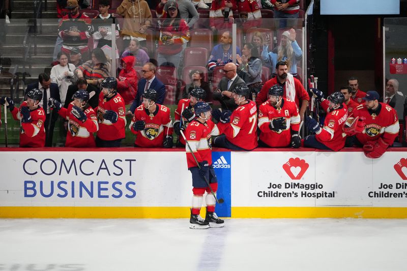 Dec 29, 2023; Sunrise, Florida, USA; Florida Panthers center Carter Verhaeghe (23) celebrates his goal against the New York Rangers with teammates on the bench during the third period at Amerant Bank Arena. Mandatory Credit: Jasen Vinlove-USA TODAY Sports