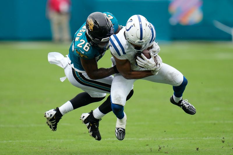 Indianapolis Colts' Josh Downs (1) is tackled by Jacksonville Jaguars' Antonio Johnson (26) during the second half of an NFL football game, Sunday, Oct. 6, 2024, in Jacksonville, Fla. (AP Photo/John Raoux)