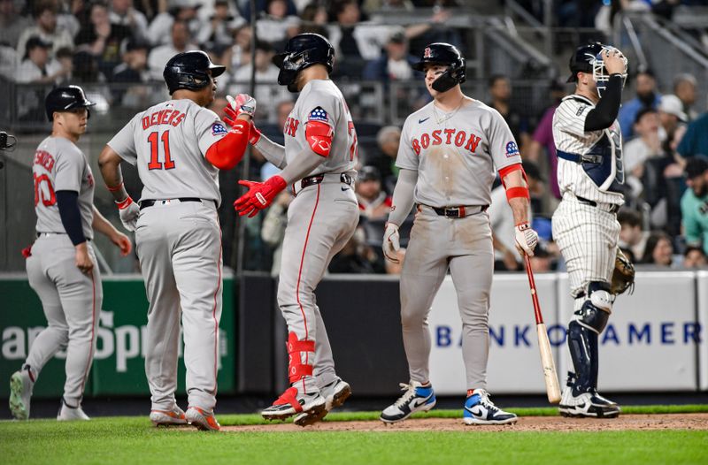 Jun 8, 2025; Bronx, New York, USA; Boston Red Sox catcher Carlos Narváez (75) is greeted at home plate by designated hitter Rafael Devers (11) after hitting a three-run home run against the New York Yankees during the sixth inning at Yankee Stadium. Mandatory Credit: John Jones-Imagn Images