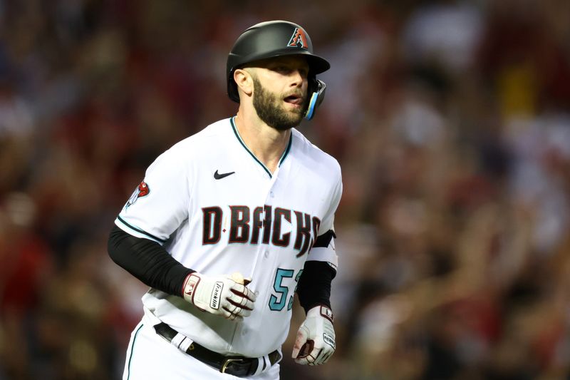 Oct 11, 2023; Phoenix, Arizona, USA; Arizona Diamondbacks first baseman Christian Walker (53) rounds the bases after hitting a home run against the Los Angeles Dodgers in the third inning for game three of the NLDS for the 2023 MLB playoffs at Chase Field. Mandatory Credit: Mark J. Rebilas-USA TODAY Sports