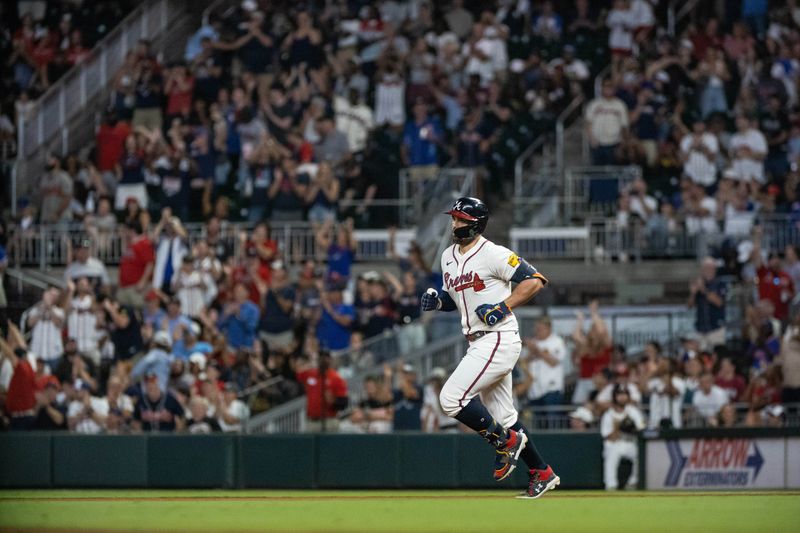 Aug 22, 2024; Cumberland, Georgia, USA; Atlanta Braves outfielder Adam Duvall (14) hits home run against the Philadelphia Phillies during the sixth inning at Truist Park. Mandatory Credit: Jordan Godfree-USA TODAY Sports