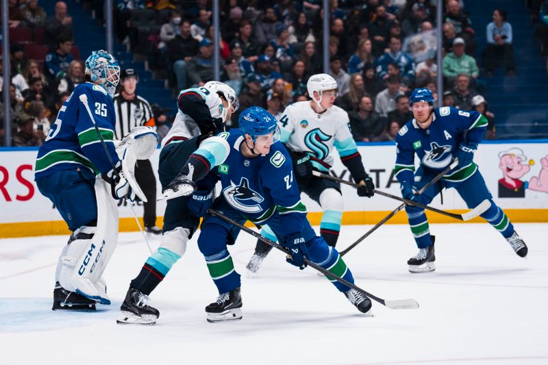 Jan 2, 2026; Vancouver, British Columbia, CAN; Vancouver Canucks defenseman Zeev Buium (24) battles with Seattle Kraken forward Matty Beniers (10) in the first period at Rogers Arena. Mandatory Credit: Bob Frid-Imagn Images
