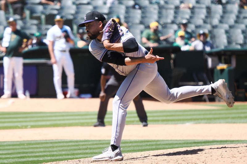 May 23, 2024; Oakland, California, USA; Colorado Rockies relief pitcher Justin Lawrence (61) pitches against the Oakland Athletics during the ninth inning at Oakland-Alameda County Coliseum. Mandatory Credit: Kelley L Cox-USA TODAY Sports