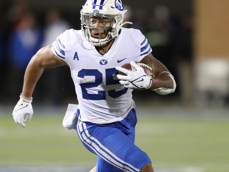 Oct 1, 2021; Logan, Utah, USA; Brigham Young Cougars running back Tyler Allgeier (25) runs during the third quarter against the Utah State Aggies at Merlin Olsen Field at Maverik Stadium. Mandatory Credit: Rob Gray-USA TODAY Sports