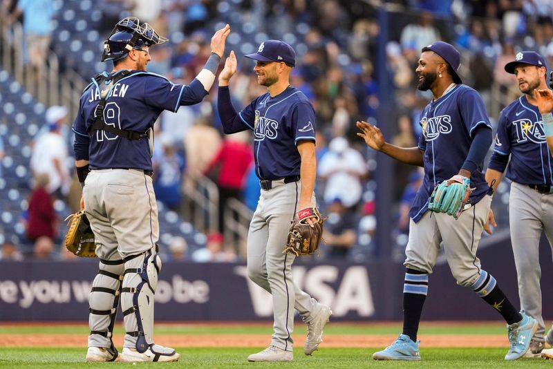 May 15, 2025; Toronto, Ontario, CAN; Tampa Bay Rays second base Brandon Lowe (8) celebrates with Tampa Bay Rays catcher Danny Jansen (19) after defeating the Toronto Blue Jays at Rogers Centre. Mandatory Credit: Kevin Sousa-Imagn Images
