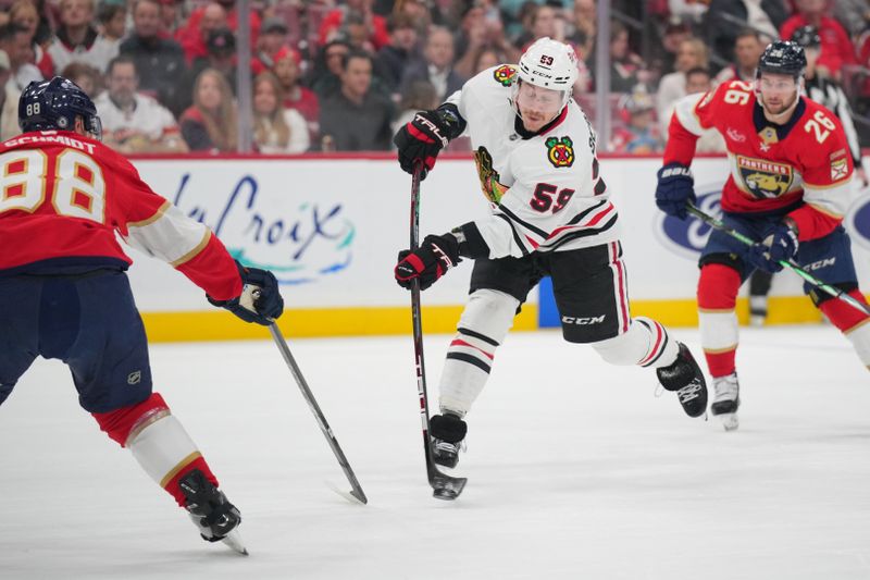 Feb 1, 2025; Sunrise, Florida, USA; Chicago Blackhawks left wing Tyler Bertuzzi (59) takes a shot on goal against the Florida Panthers in the first period at Amerant Bank Arena. Mandatory Credit: Jim Rassol-Imagn Images