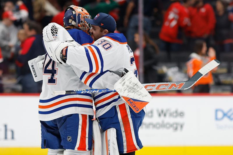 Nov 24, 2023; Washington, District of Columbia, USA; Edmonton Oilers goaltender Stuart Skinner (74) celebrates with Oilers goaltender Calvin Pickard (30) after their game against the Washington Capitals at Capital One Arena. Mandatory Credit: Geoff Burke-USA TODAY Sports