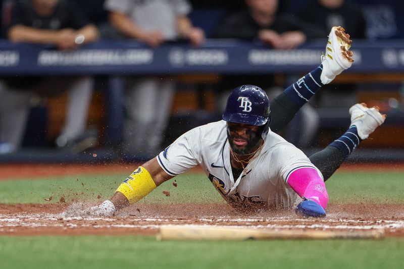 Jul 11, 2024; St. Petersburg, Florida, USA; Tampa Bay Rays first baseman Yandy Diaz (2) scores a run against the New York Yankees in the third inning  at Tropicana Field. Mandatory Credit: Nathan Ray Seebeck-USA TODAY Sports