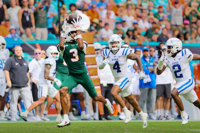 Nov 2, 2024; Miami Gardens, Florida, USA; Miami Hurricanes wide receiver Jacolby George (3) catches the football for a touchdown against the Duke Blue Devils during the fourth quarter at Hard Rock Stadium. Mandatory Credit: Sam Navarro-Imagn Images