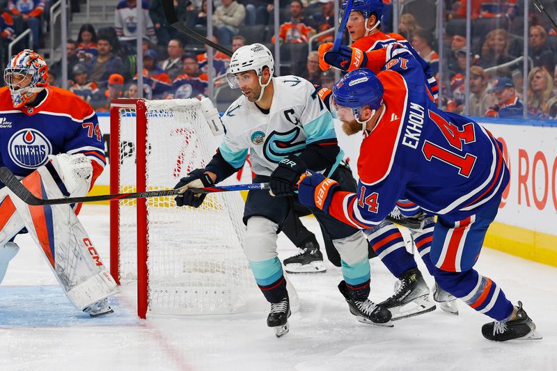 Sep 24, 2025; Edmonton, Alberta, CAN; Seattle Kraken forward Jordan Eberle (7) trips up Edmonton Oilers defensemen Mattias Ekholm (14) during the second period at Rogers Place. Mandatory Credit: Perry Nelson-Imagn Images