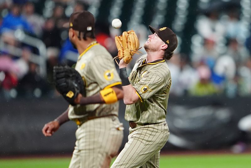 Jun 14, 2024; New York City, New York, USA; San Diego Padres second baseman Jake Cronenworth (9) catches a fly ball hit by New York Mets third baseman Mark Vientos (not pictured) during the fourth inning at Citi Field. Mandatory Credit: Gregory Fisher-USA TODAY Sports