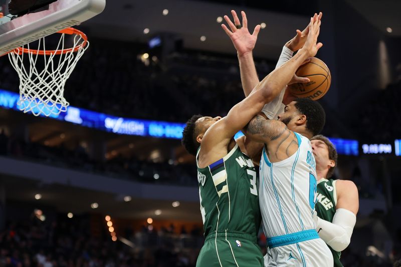 MILWAUKEE, WISCONSIN - FEBRUARY 09: Miles Bridges #0 of the Charlotte Hornets is fouled by Giannis Antetokounmpo #34 of the Milwaukee Bucks during a game at Fiserv Forum on February 09, 2024 in Milwaukee, Wisconsin. NOTE TO USER: User expressly acknowledges and agrees that, by downloading and or using this photograph, User is consenting to the terms and conditions of the Getty Images License Agreement. (Photo by Stacy Revere/Getty Images)