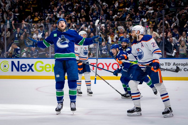 May 16, 2024; Vancouver, British Columbia, CAN; Edmonton Oilers forward Leon Draisaitl (29) looks on as Vancouver Canucks defenseman Carson Soucy (7) celebrates his goal during the first period in game five of the second round of the 2024 Stanley Cup Playoffs at Rogers Arena. Mandatory Credit: Bob Frid-USA TODAY Sports