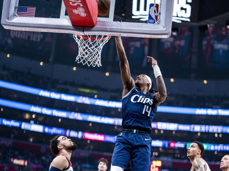 LOS ANGELES, CA - MARCH 1: Terance Mann #14 of the LA Clippers dunks the ball during the game against the Washington Wizards on March 1, 2024 at Crypto.Com Arena in Los Angeles, California. NOTE TO USER: User expressly acknowledges and agrees that, by downloading and/or using this Photograph, user is consenting to the terms and conditions of the Getty Images License Agreement. Mandatory Copyright Notice: Copyright 2024 NBAE (Photo by Tyler Ross/NBAE via Getty Images)