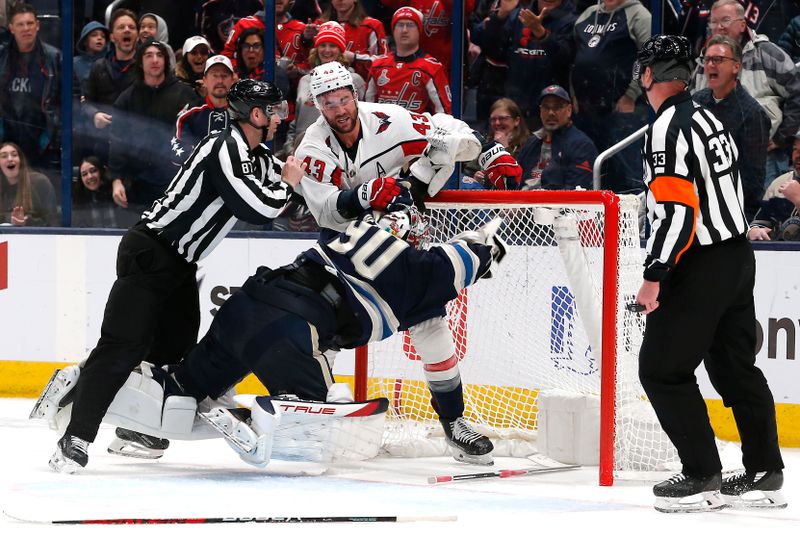 Dec 21, 2023; Columbus, Ohio, USA; Washington Capitals right wing Tom Wilson (43) and Columbus Blue Jackets goalie Elvis Merzlikins (90) battle during overtime at Nationwide Arena. Mandatory Credit: Russell LaBounty-USA TODAY Sports