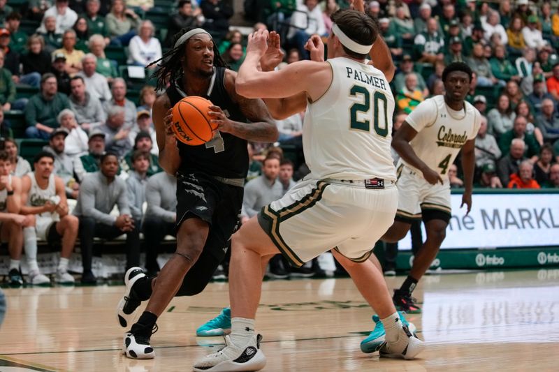 Feb 27, 2024; Fort Collins, Colorado, USA; Nevada Wolf Pack forward Tre Coleman (4) drives against Colorado State Rams guard Joe Palmer (20) during the first half  at Moby Arena. Mandatory Credit: Michael Madrid-USA TODAY Sports