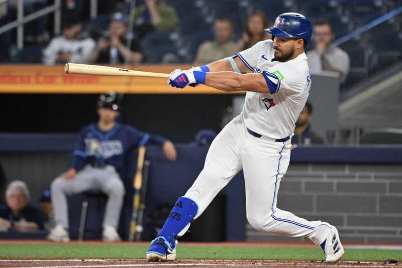 May 14, 2025; Toronto, Ontario, CAN;  Toronto Blue Jays designated hitter Anthony Santander (25) hits a single against the Tampa Bay Rays in the first inning at Rogers Centre. Mandatory Credit: Dan Hamilton-Imagn Images