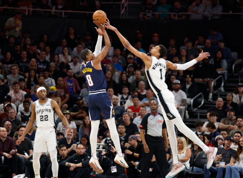 AUSTIN, TX - MARCH 15: Victor Wembanyama #1 of the San Antonio Spurs blocks the shot of Peyton Watson #8 of the Denver Nuggets in the first half at Moody Center on March 15, 2024 in Austin, Texas. NOTE TO USER: User expressly acknowledges and agrees that, by downloading and or using this photograph, User is consenting to terms and conditions of the Getty Images License Agreement. (Photo by Ronald Cortes/Getty Images)