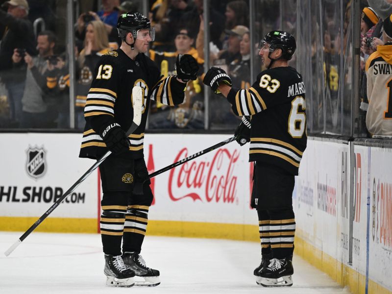 Nov 9, 2023; Boston, Massachusetts, USA; Boston Bruins center Charlie Coyle (13) high-fives left wing Brad Marchand (63) after a game against the New York Islanders at the TD Garden. Mandatory Credit: Brian Fluharty-USA TODAY Sports