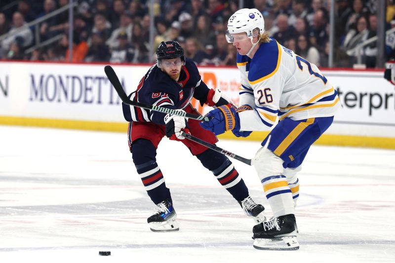 Mar 23, 2025; Winnipeg, Manitoba, CAN; Buffalo Sabres defenseman Rasmus Dahlin (26) is checked by Winnipeg Jets left wing Kyle Connor (81) in the second period at Canada Life Centre. Mandatory Credit: James Carey Lauder-Imagn Images