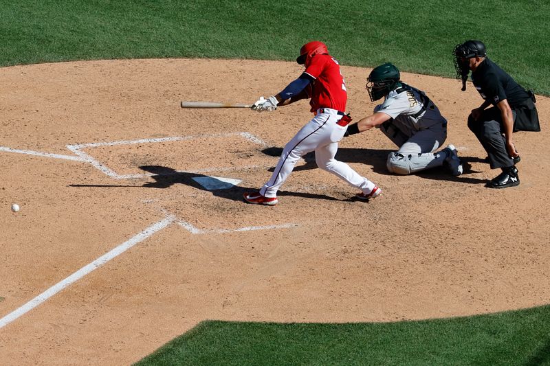 Aug 13, 2023; Washington, District of Columbia, USA; Washington Nationals left fielder Stone Garrett (36) hits an RBI single against the Oakland Athletics during the ninth inning at Nationals Park. Mandatory Credit: Geoff Burke-USA TODAY Sports