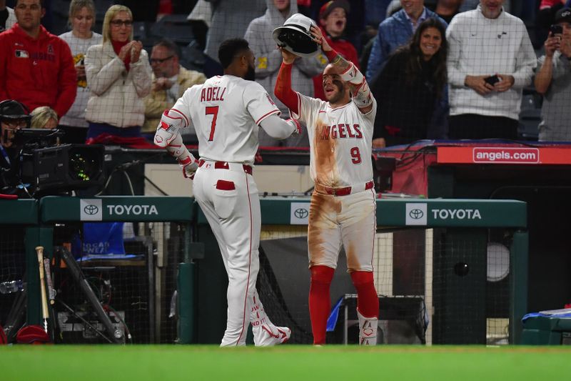 May 6, 2025; Anaheim, California, USA; Los Angeles Angels outfielder Jo Adell (7) is greeted by shortstop Zach Neto (9) after hitting a solo home run against the Toronto Blue Jays during the eighth inning at Angel Stadium. Mandatory Credit: Gary A. Vasquez-Imagn Images