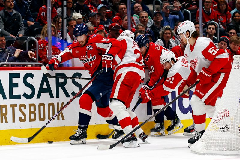 Mar 18, 2025; Washington, District of Columbia, USA; Washington Capitals right wing Taylor Raddysh (16) goes for the puck against Detroit Red Wings defenseman Albert Johansson (20) during the first period at Capital One Arena. Mandatory Credit: Peter Casey-Imagn Images