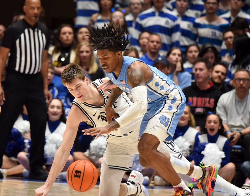 Feb 4, 2023; Durham, North Carolina, USA; North Carolina Tar Heels guard Caleb Love (2) and Duke Blue Devils center Kyle Filipowski(30) battle for a loose ball during the second half at Cameron Indoor Stadium.  The Blue Devils won 63-57. Mandatory Credit: Rob Kinnan-USA TODAY Sports
