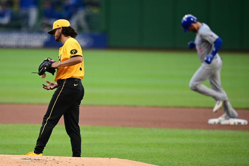 May 10, 2024; Pittsburgh, Pennsylvania, USA; Pittsburgh Pirates starting pitcher Jared Jones (37) waits for Chicago Cubs designated hitter Cody Ballinger (24) to run the bases after hitting a solo home run in the first inning at PNC Park. Mandatory Credit: David Dermer-USA TODAY Sports