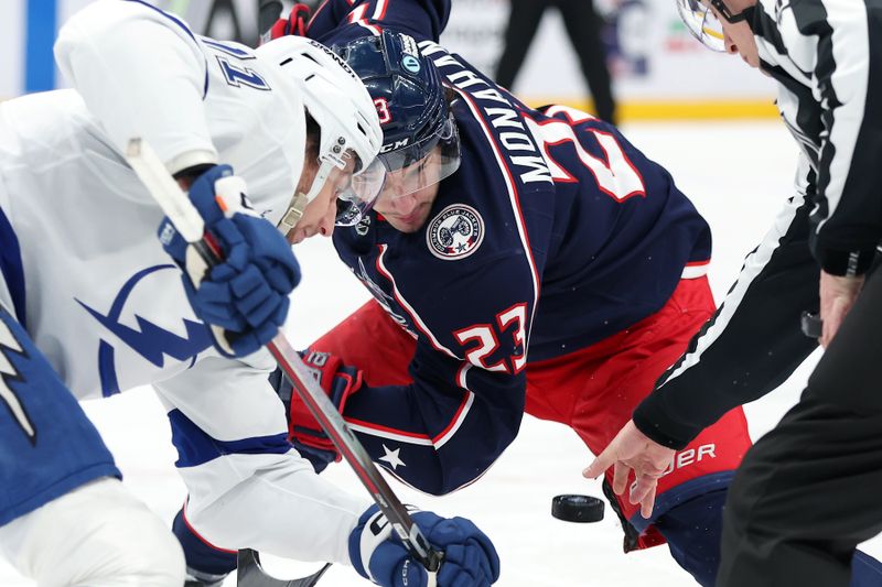 Jan 24, 2026; Columbus, Ohio, USA;  Columbus Blue Jackets center Sean Monahan (23) looks at the puck as he faces off with Tampa Bay Lightning center Anthony Cirelli (71) during the second period at Nationwide Arena. Mandatory Credit: Joseph Maiorana-Imagn Images