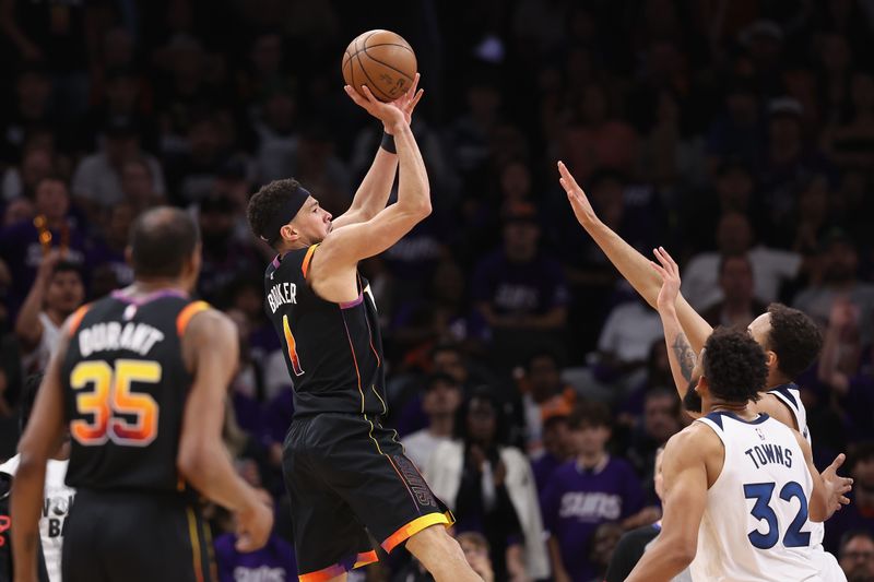 PHOENIX, ARIZONA - APRIL 28: Devin Booker #1 of the Phoenix Suns puts up shot over Kyle Anderson #1 of the Minnesota Timberwolves during the first half of game four of the Western Conference First Round Playoffs at Footprint Center on April 28, 2024 in Phoenix, Arizona. NOTE TO USER: User expressly acknowledges and agrees that, by downloading and or using this photograph, User is consenting to the terms and conditions of the Getty Images License Agreement.  (Photo by Christian Petersen/Getty Images)