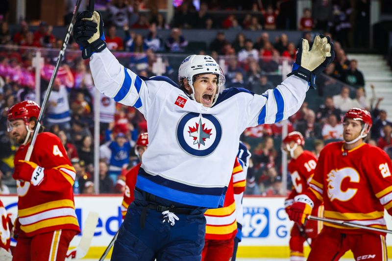 Feb 19, 2024; Calgary, Alberta, CAN; Winnipeg Jets center Sean Monahan (23) celebrates his goal against the Calgary Flames during the first period at Scotiabank Saddledome. Mandatory Credit: Sergei Belski-USA TODAY Sports