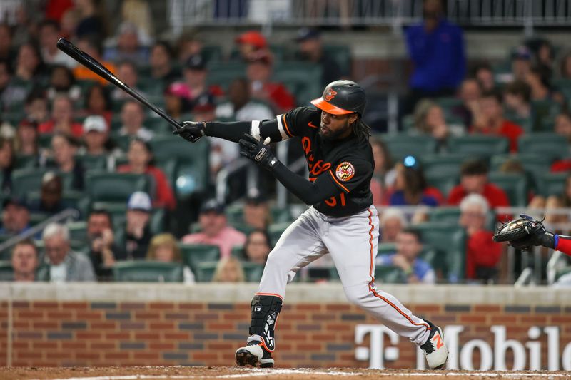 May 6, 2023; Atlanta, Georgia, USA; Baltimore Orioles center fielder Cedric Mullins (31) hits a single against the Atlanta Braves in the seventh inning at Truist Park. Mandatory Credit: Brett Davis-USA TODAY Sports