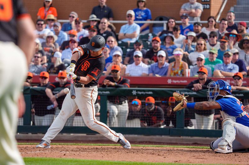 Feb 24, 2024; Scottsdale, Arizona, USA; San Francisco Giants infielder Yoshi Tsutsugo (34) hits a single in the ninth against the Chicago Cubs during spring training game at Scottsdale Stadium. Mandatory Credit: Allan Henry-USA TODAY Sports