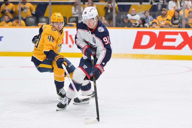 Oct 9, 2025; Nashville, Tennessee, USA; Columbus Blue Jackets center Kent Johnson (91) steals the puck from Nashville Predators center Fedor Svechkiv (40) during the first period at Bridgestone Arena. Mandatory Credit: Steve Roberts-Imagn Images