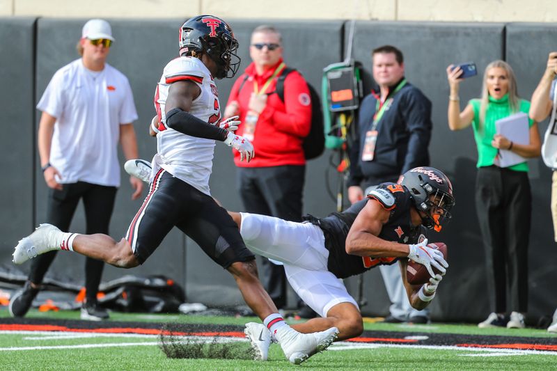 Oct 8, 2022; Stillwater, Oklahoma, USA;  Oklahoma State Cowboys wide receiver Bryson Green (9) catches a pass for a first down against Texas Tech Red Raiders defensive back Malik Dunlap (24) in the second quarter at Boone Pickens Stadium. Mandatory Credit: Nathan J Fish/The Oklahoman - USA TODAY NETWORK