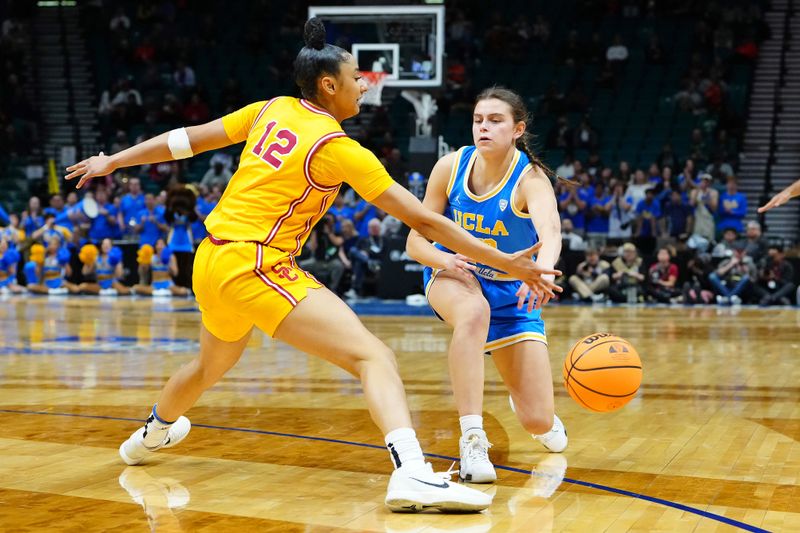 Mar 8, 2024; Las Vegas, NV, USA; UCLA Bruins forward Gabriela Jaquez (23) makes a pass under the arm of USC Trojans guard JuJu Watkins (12) during the first quarter at MGM Grand Garden Arena. Mandatory Credit: Stephen R. Sylvanie-USA TODAY Sports