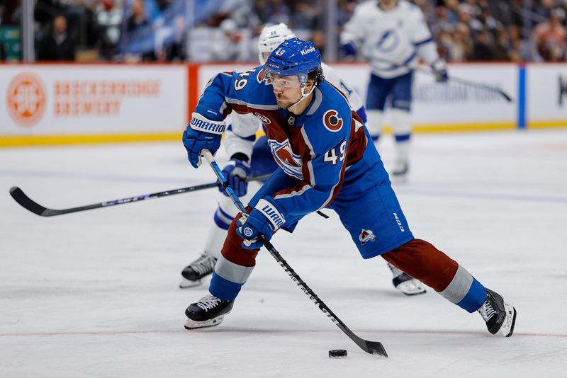 Oct 30, 2024; Denver, Colorado, USA; Colorado Avalanche defenseman Samuel Girard (49) attempts a shot in the second period against the Tampa Bay Lightning at Ball Arena. Mandatory Credit: Isaiah J. Downing-Imagn Images