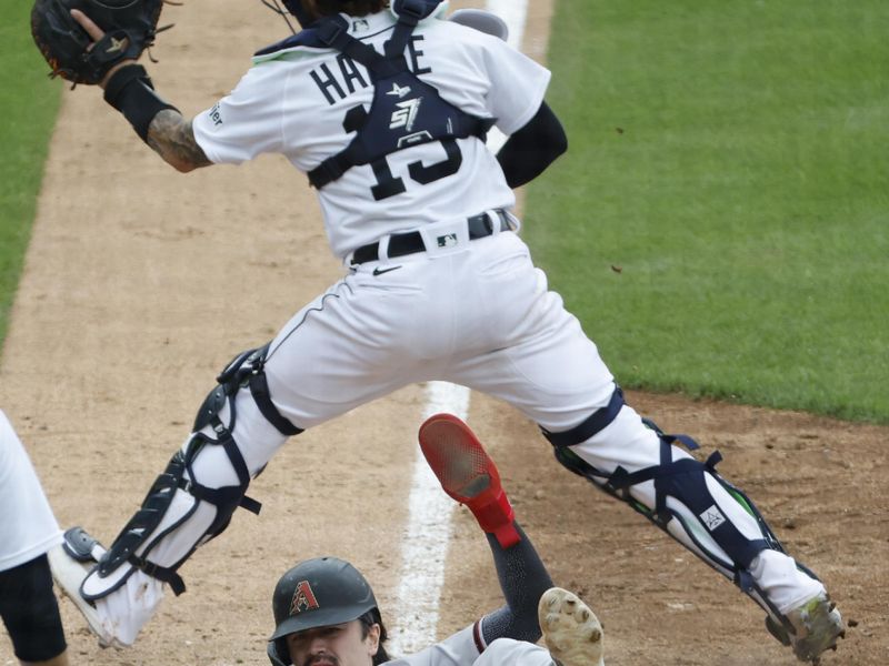 Jun 11, 2023; Detroit, Michigan, USA;  Arizona Diamondbacks left fielder Corbin Carroll (7) slides in safe at home in the ninth inning against the Detroit Tigers at Comerica Park. Mandatory Credit: Rick Osentoski-USA TODAY Sports