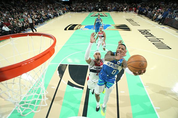 MILWAUKEE, WI - NOVEMBER 24: Damian Lillard #0 of the Milwaukee Bucks drives to the basket during the game against the Washington Wizards during the In-Season Tournament on November 24, 2023 at the Fiserv Forum Center in Milwaukee, Wisconsin. NOTE TO USER: User expressly acknowledges and agrees that, by downloading and or using this Photograph, user is consenting to the terms and conditions of the Getty Images License Agreement. Mandatory Copyright Notice: Copyright 2023 NBAE (Photo by Gary Dineen/NBAE via Getty Images).