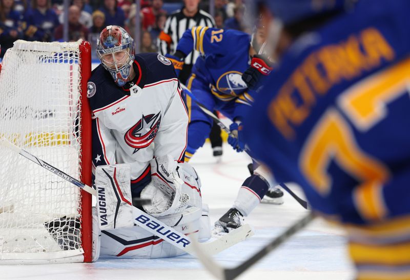 Dec 30, 2023; Buffalo, New York, USA;  Columbus Blue Jackets goaltender Daniil Tarasov (40) looks to make a save on a shot by Buffalo Sabres right wing JJ Peterka (77) during the second period at KeyBank Center. Mandatory Credit: Timothy T. Ludwig-USA TODAY Sports